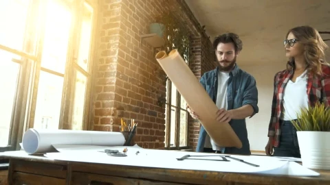 Stock Video Designers Unroll Plans Onto Desk In Studio Live Wallpaper For PC - Free Live Wallpaper