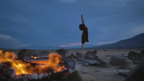 Stock Video Deserted Plain With A Campfire And A Woman Practicing Yoga Live Wallpaper For PC - Free Live Wallpaper