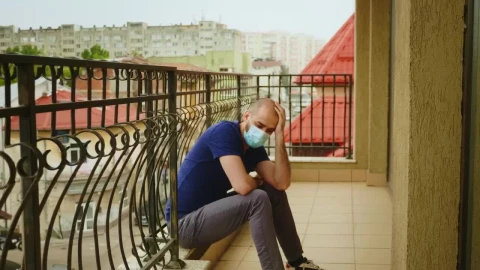 Stock Video Depressed Man Wearing Mask Sits On Balcony In Covid Lockdown Live Wallpaper For PC - Free Live Wallpaper