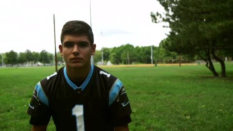 Stock Video Football Player Putting On A Blue Helmet Live Wallpaper For PC - Free Live Wallpaper