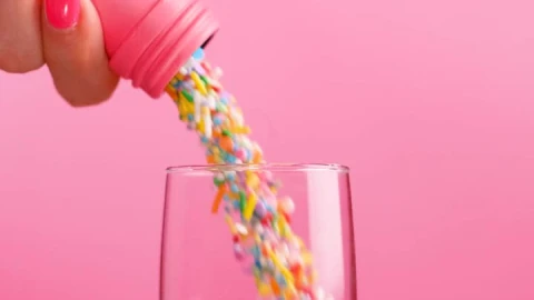 Stock Video Filling A Glass Cup With Small Sweets On A Pink Live Wallpaper For PC - Free Live Wallpaper