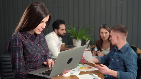 Stock Video Female Team Leader Holding Laptop Turns And Smiles Live Wallpaper For PC - Free Live Wallpaper