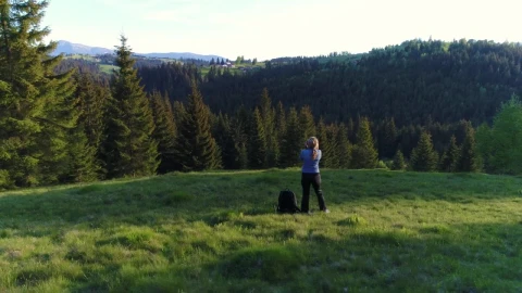 Stock Video Female Photographer Taking Pictures In A Forest Meadow Live Wallpaper For PC - Free Live Wallpaper