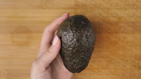 Stock Video Female Hands Cutting An Avocado In The Kitchen Live Wallpaper For PC - Free Live Wallpaper