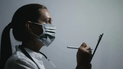 Stock Video Female Doctor Writing Notes On A Patients Record Live Wallpaper For PC - Free Live Wallpaper