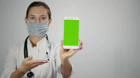 Stock Video Female Doctor Displaying Mobile With Green Screen Live Wallpaper For PC - Free Live Wallpaper