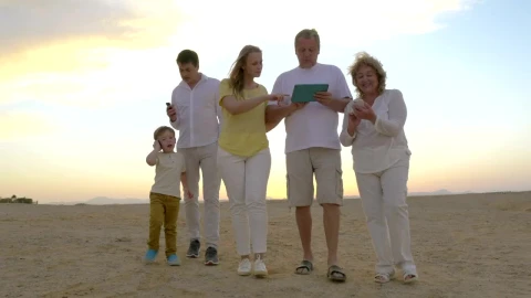 Stock Video Family Walking Along The Beach With A Tablet Live Wallpaper For PC - Free Live Wallpaper