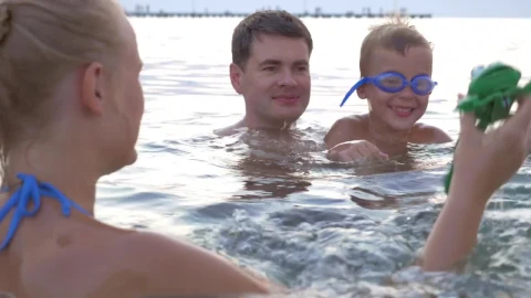 Stock Video Family Playing With A Toy In The Ocean Live Wallpaper For PC - Free Live Wallpaper