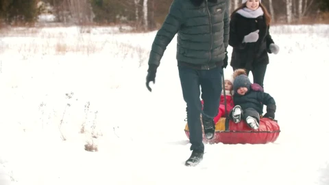 Stock Video Family Playing In The Snow With An Inflatable Sled Live Wallpaper For PC - Free Live Wallpaper