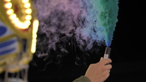 Stock Video Hand Holding A Multicolored Smoke Bomb At The Fair Live Wallpaper For PC - Free Live Wallpaper