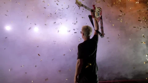 Stock Video Guitarist Raising His Guitar On A Smoky Stage Live Wallpaper For PC - Free Live Wallpaper