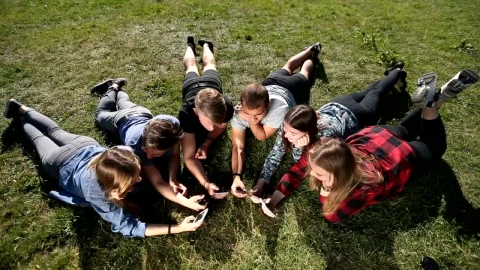 Stock Video Friends With Their Cellphones Lying Outdoors Live Wallpaper For PC - Free Live Wallpaper