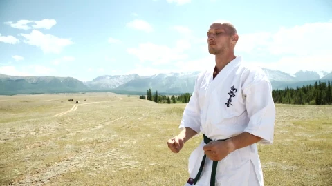 Stock Video Karate Black Belt Meditating In Open Field Landscape Animated Wallpaper - Free Live Wallpaper