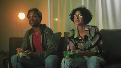 Stock Video Interracial Couple Playing Video Games On The Sofa Animated Wallpaper - Free Live Wallpaper