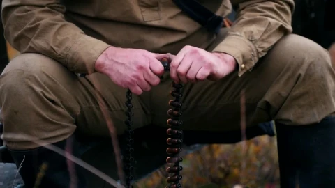 Stock Video Hunter Loading A Belt Of Bullets In A Nearby Shot Animated Wallpaper - Free Live Wallpaper