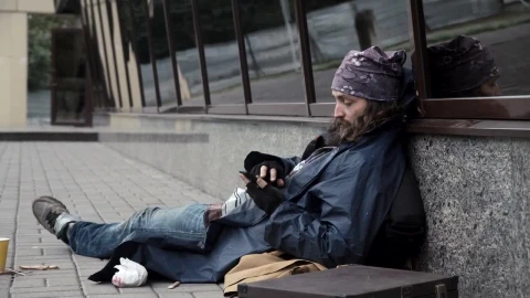 Stock Video Homeless Man Checking The Mobile Phone On The Sidewalk Animated Wallpaper - Free Live Wallpaper