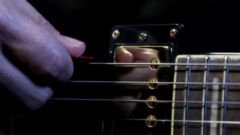 Stock Video Holding A Guitar Pick Animated Wallpaper - Free Live Wallpaper