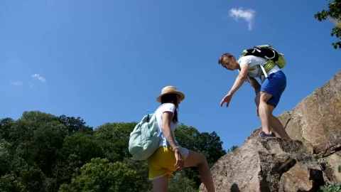 Stock Video Hiking Man Helping His Partner Climb Animated Wallpaper - Free Live Wallpaper