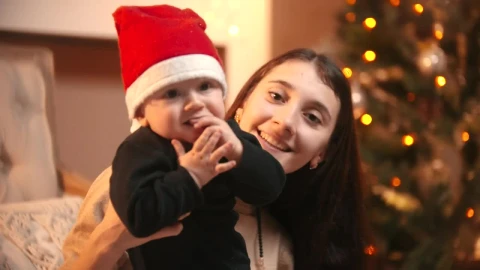 Stock Video Happy Mom Holding Her Baby At Christmas Animated Wallpaper - Free Live Wallpaper