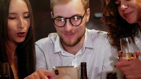 Stock Video Happy Friends Looking At Photo In A Bar Animated Wallpaper - Free Live Wallpaper