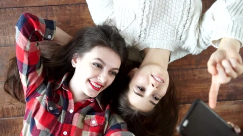 Stock Video Happy Female Friends Taking Selfies On The Floor Animated Wallpaper - Free Live Wallpaper