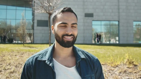 Stock Video Handsome Arab Man Smiles At Camera Outside Building Animated Wallpaper - Free Live Wallpaper