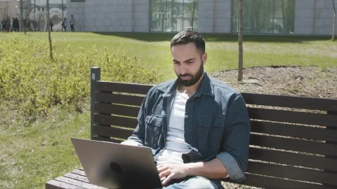 Stock Video Handsome Arab Man Sitting On Park Bench With Laptop Animated Wallpaper - Free Live Wallpaper