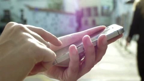 Stock Video Hands Using A Mobile Phone On The Street Animated Wallpaper - Free Live Wallpaper