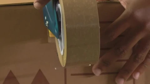 Stock Video Hands Of Two People Sealing A Package With Tape Animated Wallpaper - Free Live Wallpaper