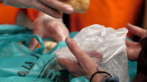 Stock Video Hands Of A Volunteer Gives Bread To Hungry People Animated Wallpaper - Free Live Wallpaper