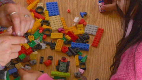 Stock Video Hands Of A Mother And Daughter Playing With Legos Animated Wallpaper - Free Live Wallpaper