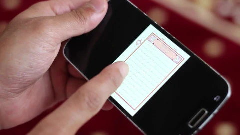 Stock Video Hands Hold A Cell To Reading The Quran In Digital Animated Wallpaper - Free Live Wallpaper