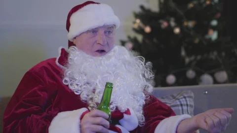 Stock Video Man In Santa Costume Drinks Beer On Sofa Animated Wallpaper - Free Live Wallpaper