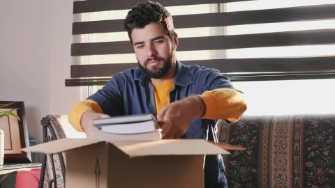 Stock Video Man In His Living Room Finishes Packing A Box To Animated Wallpaper - Free Live Wallpaper