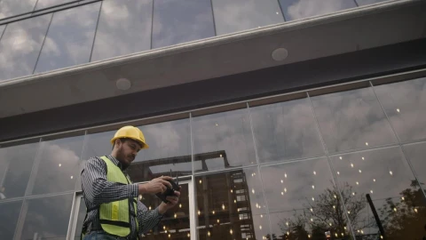 Stock Video Man In Hard Hat Flying A Drone Animated Wallpaper - Free Live Wallpaper