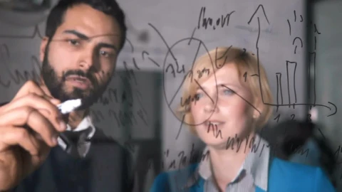 Stock Video Man Illustrates Idea On Glass Wall To Coworker Animated Wallpaper - Free Live Wallpaper