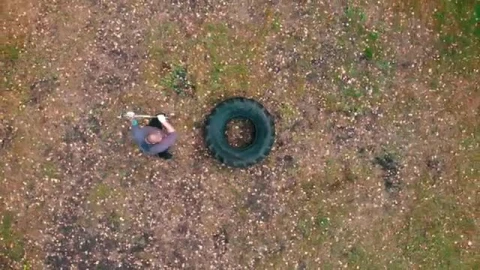Stock Video Man Hitting A Large Truck Tire With A Mallet Smal Animated Wallpaper - Free Live Wallpaper
