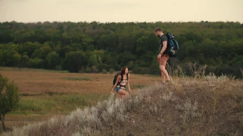 Stock Video Man Helps His Friend To Climb A Mound In Nature Animated Wallpaper - Free Live Wallpaper
