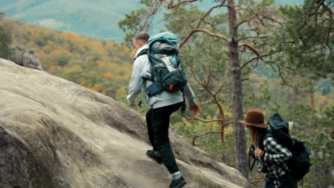 Stock Video Man Helps Girlfriend Climb Up Rock During Hike Animated Wallpaper - Free Live Wallpaper