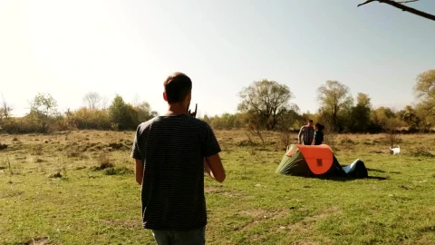 Stock Video Man Helps Friends Start Fire On Camping Trip Animated Wallpaper - Free Live Wallpaper