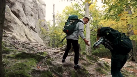 Stock Video Man Helping Woman Up Hill While Hiking Animated Wallpaper - Free Live Wallpaper