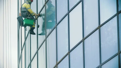 Stock Video Man Hanging On Ropes Cleaning Windows In A Building Animated Wallpaper - Free Live Wallpaper