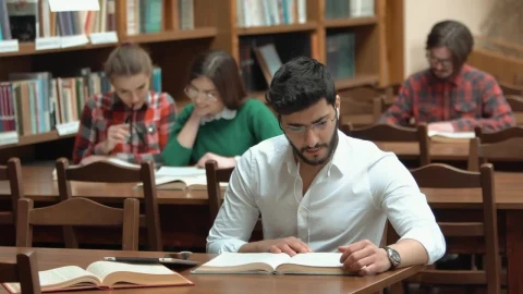 Stock Video Man Focused On Study For Exam In Library Animated Wallpaper - Free Live Wallpaper