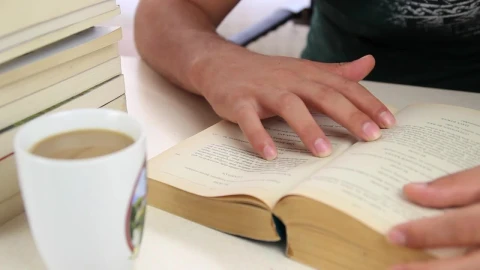 Stock Video Man Drinks Coffee From A Mug While Studying Animated Wallpaper - Free Live Wallpaper