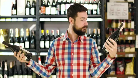 Stock Video Man Confused Over Which Wine To Buy Animated Wallpaper - Free Live Wallpaper