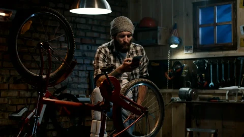 Stock Video Man Checking His Phone In The Garage Animated Wallpaper - Free Live Wallpaper