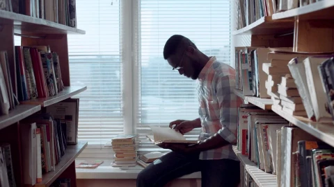 Stock Video Man Checking Books In The Library Animated Wallpaper - Free Live Wallpaper
