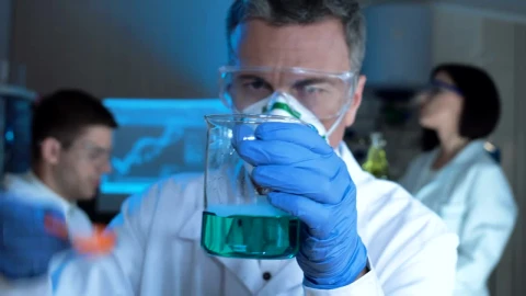 Stock Video Man Checking A Chemical Flask With Blue Liquid Animated Wallpaper - Free Live Wallpaper