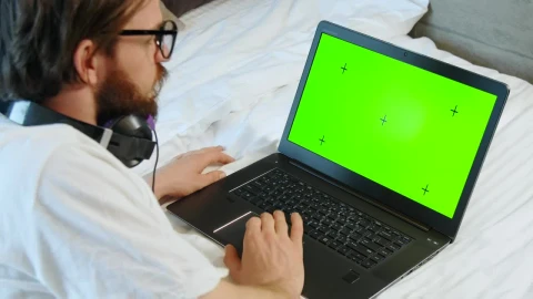 Stock Video Man Browses Greenscreen Website On Laptop In Bed Animated Wallpaper - Free Live Wallpaper