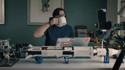 Stock Video Man At His Laptop In His Study With Many Objects Animated Wallpaper - Free Live Wallpaper